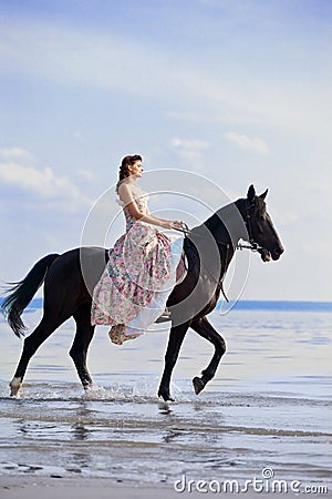 Woman on a horse by the sea Stock Photo