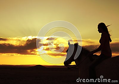Woman and Horse Watching Sunset Silhouette Stock Photo
