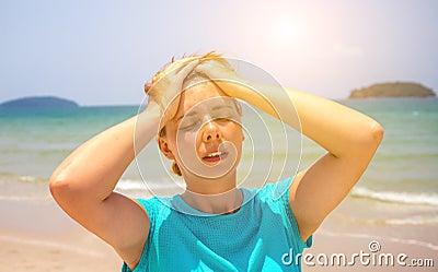 Woman on hot beach with sunstroke. Health problem on holiday. Medicine on vacation. Stock Photo