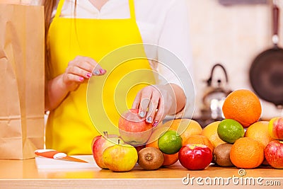 Woman housewife in kitchen with many fruits Stock Photo