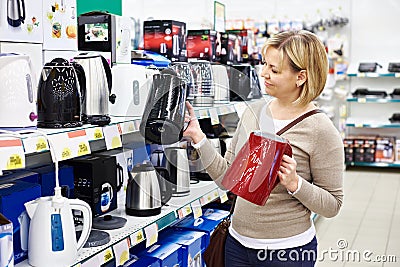 Woman housewife shopping for electric kettle Stock Photo