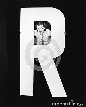 Woman with huge letter R Stock Photo