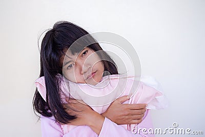 Woman hugging pillow on white background. with delusion because sleepless. health problems can not sleep from worry, broken heart Stock Photo