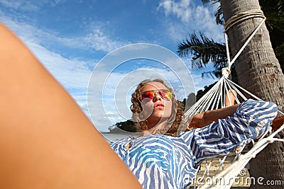 Woman in hummock on tropical beach Stock Photo