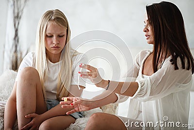 Woman hygene concept. Periods. Menstrual cycle. Mother explains daughter how to use hygiene pads and tampons. Woman and Stock Photo