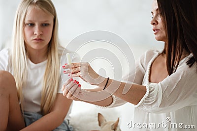 Woman hygene concept. Periods. Menstrual cycle. Mother explains daughter how to use hygiene pads and tampons. Woman and Stock Photo