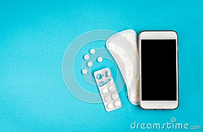 Woman hygiene protection. Sanitary pads and mobile phone on blue background. Menstrual cycle tracking Stock Photo