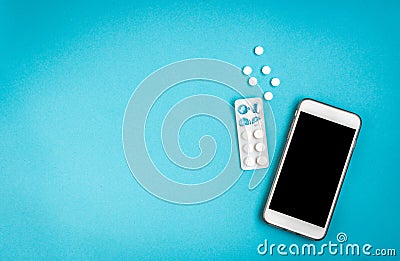 Woman hygiene protection. Sanitary pads and mobile phone on blue background. Menstrual cycle tracking Stock Photo