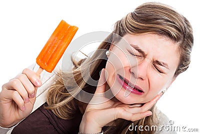 Woman with hypersensitive teeth eating ice lolly Stock Photo