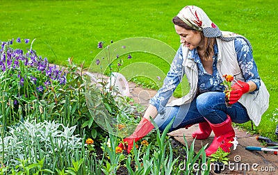 Woman in the image of a gardener planting Stock Photo