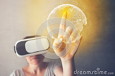 Woman immersed in virtual reality pointing to Great Britain Stock Photo