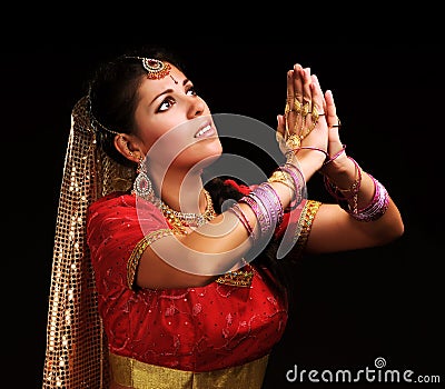 Woman in indian costume raises hands up Stock Photo