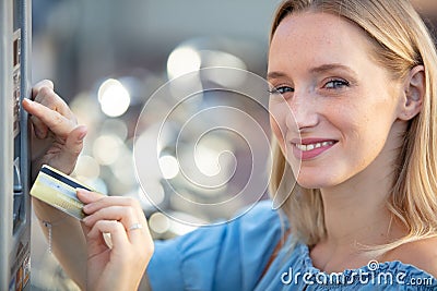 woman inserting bankcard into machine Stock Photo