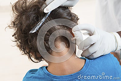 Woman inspect childs head of schoolchild for lice. Stock Photo