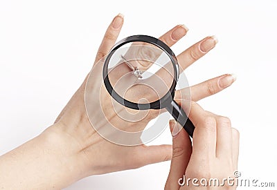 Woman inspecting diamond ring, Stock Photo