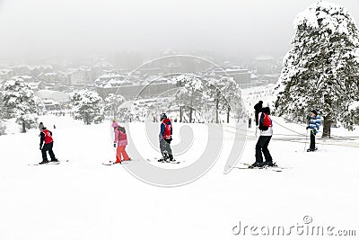 Woman instructor teaches child how to ski Editorial Stock Photo
