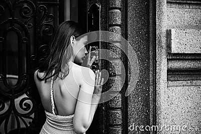 Woman intercom button doorbell at building entrance. Young dress guest lady female entering door code. Stock Photo