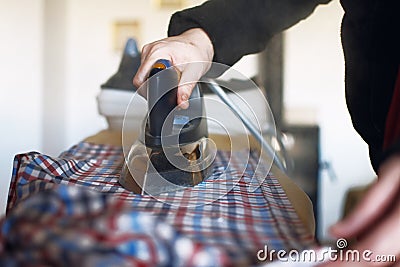 Woman with an iron, ironing clothes Stock Photo