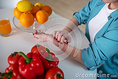 Woman itching her hand because she is alergic to products Stock Photo