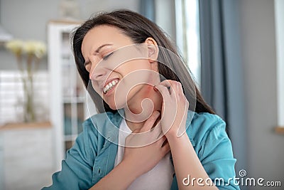 Woman itching her neck because of alergy Stock Photo