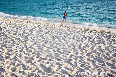 woman jogging by the sea - healthy active lifestyle Editorial Stock Photo