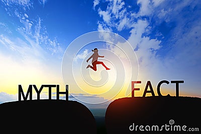 Woman jump through the gap between Myth to Fact on sunset. Stock Photo
