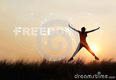 Woman jumping against sunset with word freedom Stock Photo