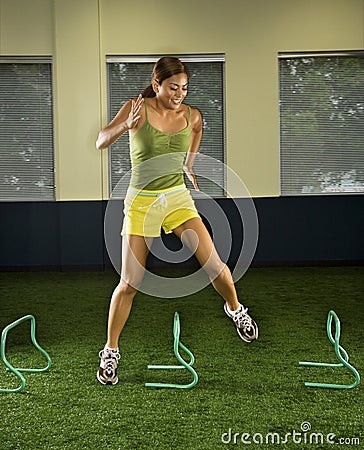 Woman jumping hurdles. Stock Photo