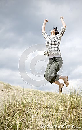 Woman jumping for joy Stock Photo