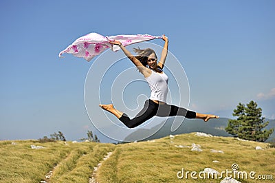 Woman jumping with a scarf Stock Photo