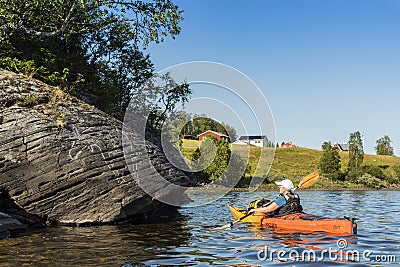 Woman in kayak looking at rock carvings with elks JÃ¤mtland Sweden Editorial Stock Photo