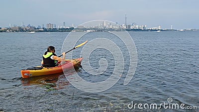 Woman kayaking on Lake Ontario near Toronto Editorial Stock Photo