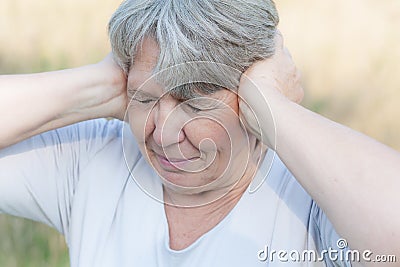 Woman keeping her ears shut Stock Photo