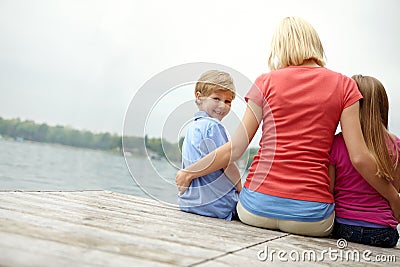 Woman, kids and back for portrait at lake during holiday with water in the outdoor with space. Family, child and mock up Stock Photo