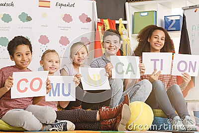 Woman and kids holding communication inscription Stock Photo