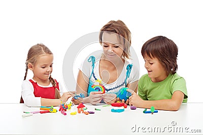 Woman and kids playing with colorful clay Stock Photo