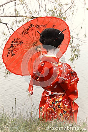 Woman in kimono with the red umbrella, back view Stock Photo