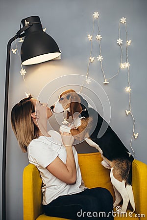 Woman kiss puppy of beagle Stock Photo