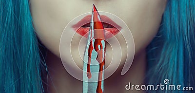 Woman kissing a knife in blood Stock Photo