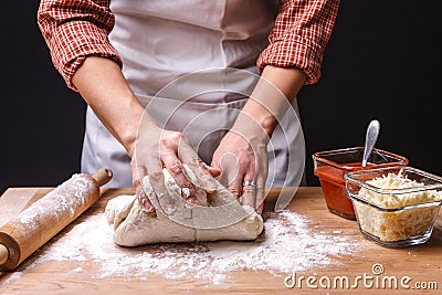 Kneading the pizza dough on a table. Stock Photo
