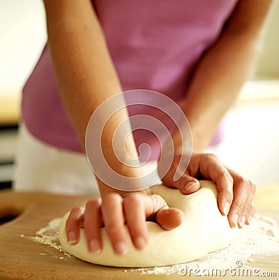 Woman kneading pizza dough Stock Photo