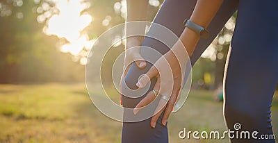 woman with knee pain in park Stock Photo