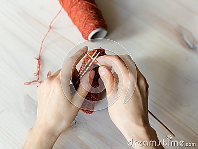 Woman knits a pattern on table Stock Photo