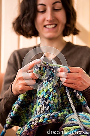 A woman knits from thick yarn Stock Photo