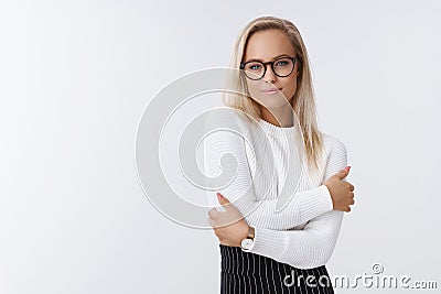 Woman knows how dress-up elegant and warm in winter posing in office over white background in trendy sweater and glasses Stock Photo
