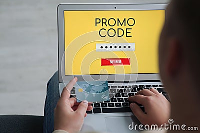 Woman with laptop activating promo code while doing online shopping, closeup Stock Photo