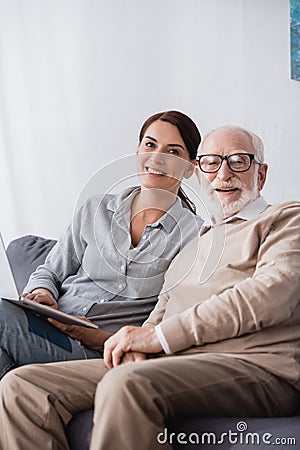 Woman with laptop and aged father Stock Photo