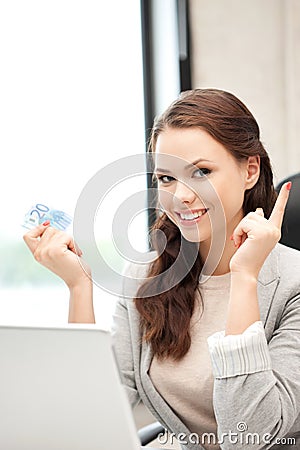 Woman with laptop computer and euro cash money Stock Photo