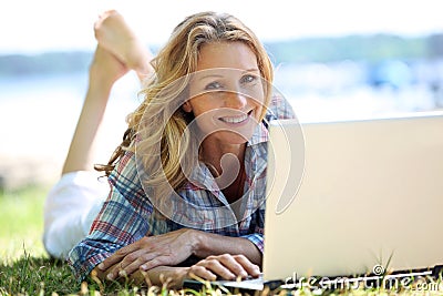 Woman on laptop outside Stock Photo