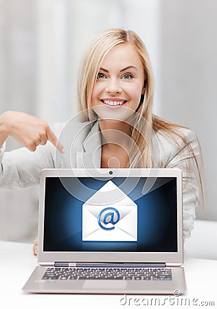 Woman with laptop pointing at email sign Stock Photo